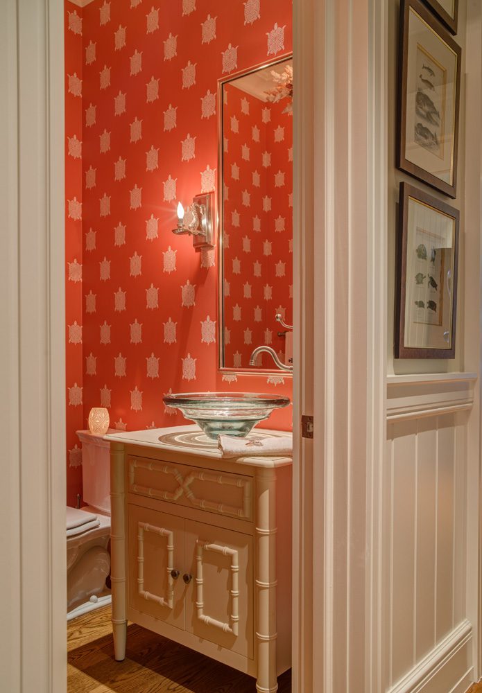 A bathroom with red walls and white trim.