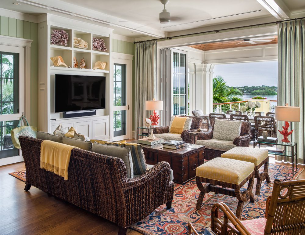 A living room with couches, chairs and tables.