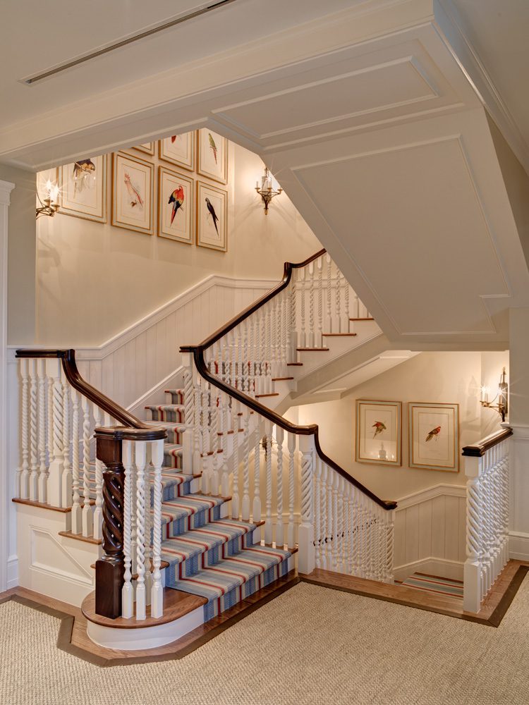 A staircase with two sets of stairs and a wall.