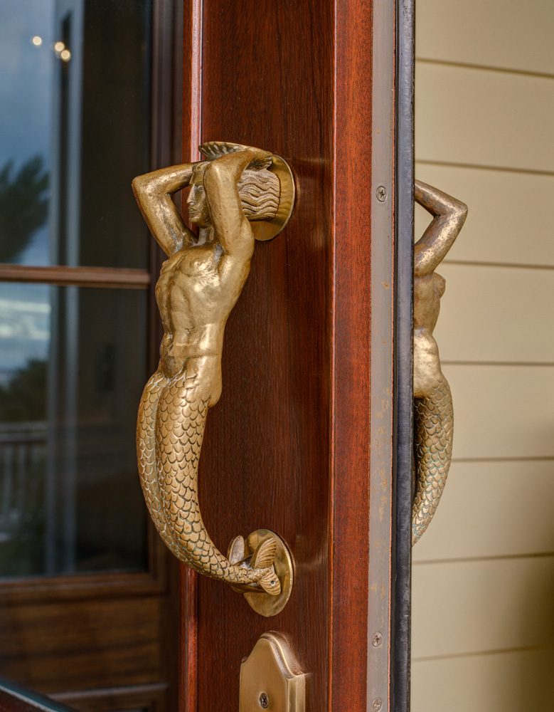 A door handle with a mermaid on it.