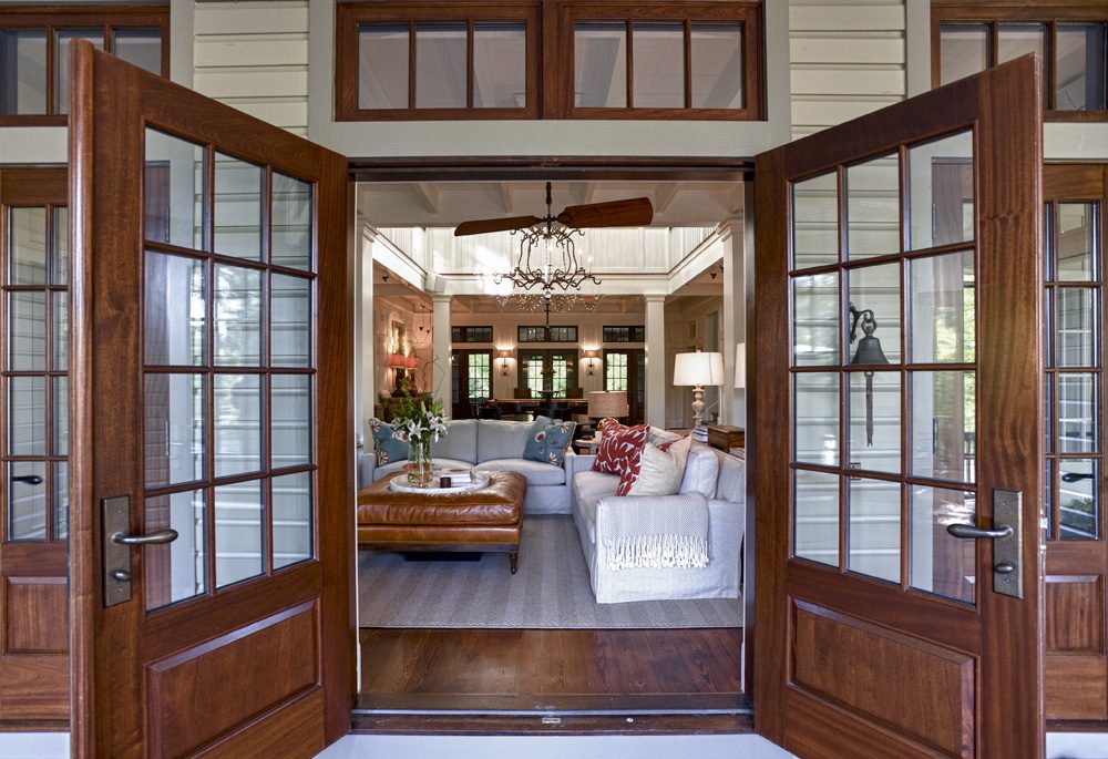 A living room with two large windows and a couch.