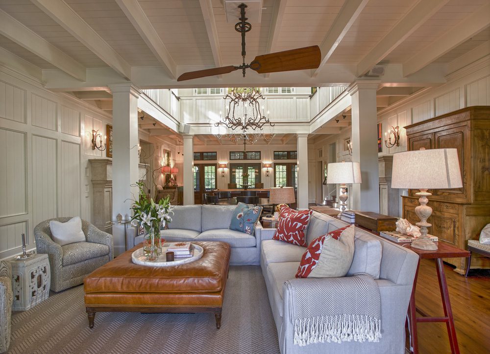 A living room with couches, pillows and a table.