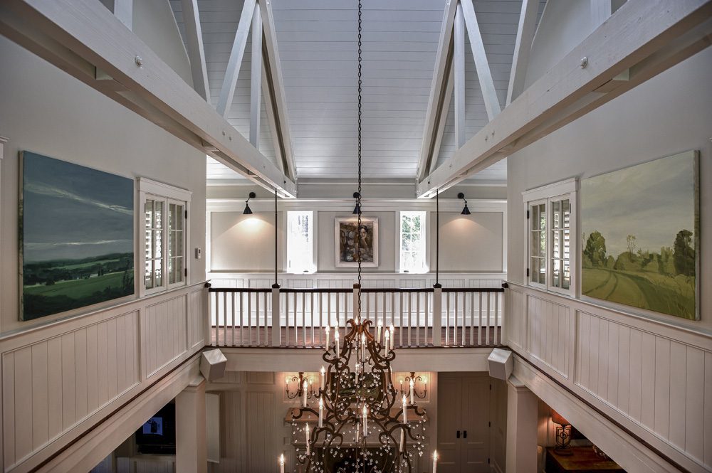 A large room with two floors and a chandelier.