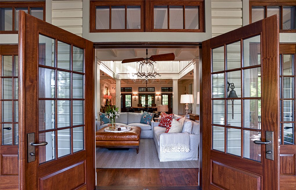 A living room with wooden doors and windows