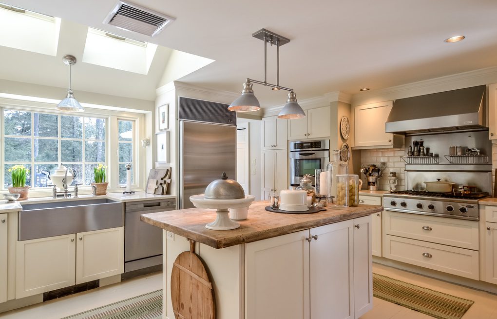 A kitchen with a large island and stainless steel appliances.